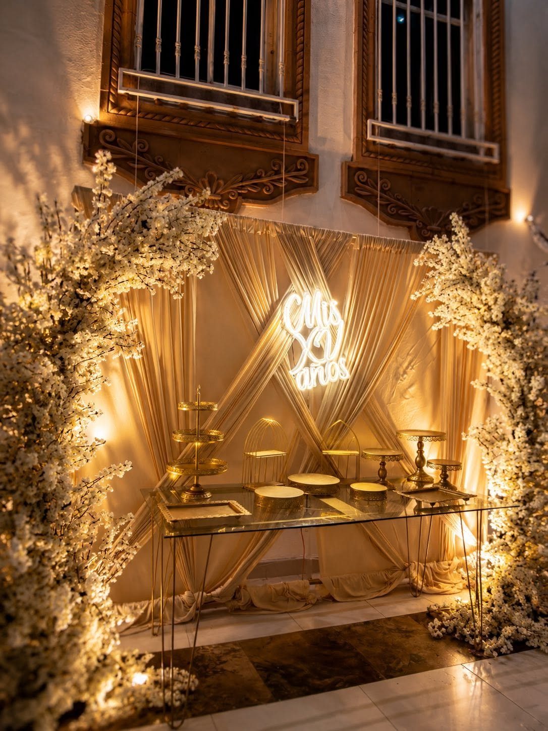 Barra de postres de XV años con iluminación cálida